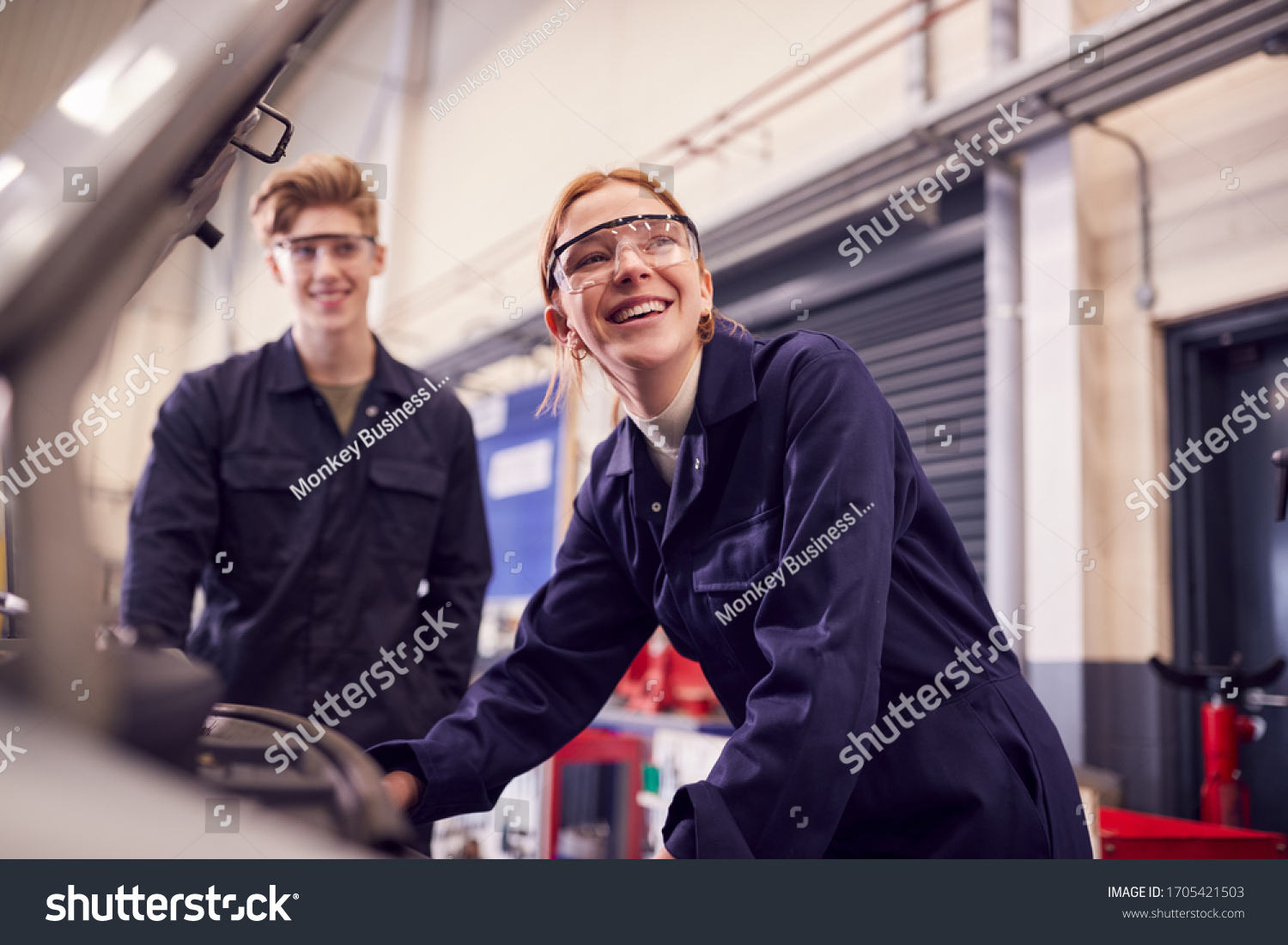 Stock Photo Male And Female Students Looking At Car Engine On Auto Mechanic Apprenticeship Course At College 1705421503
