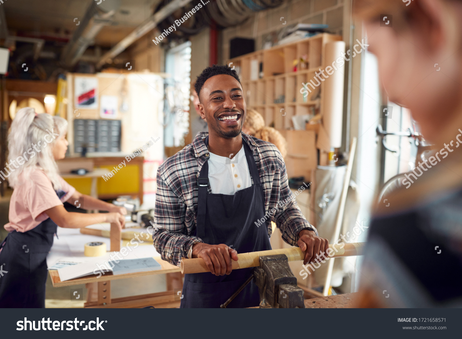 Stock Photo Multi Cultural Team In Workshop Assembling Hand Built Sustainable Bamboo Bicycle Frame 1721658571