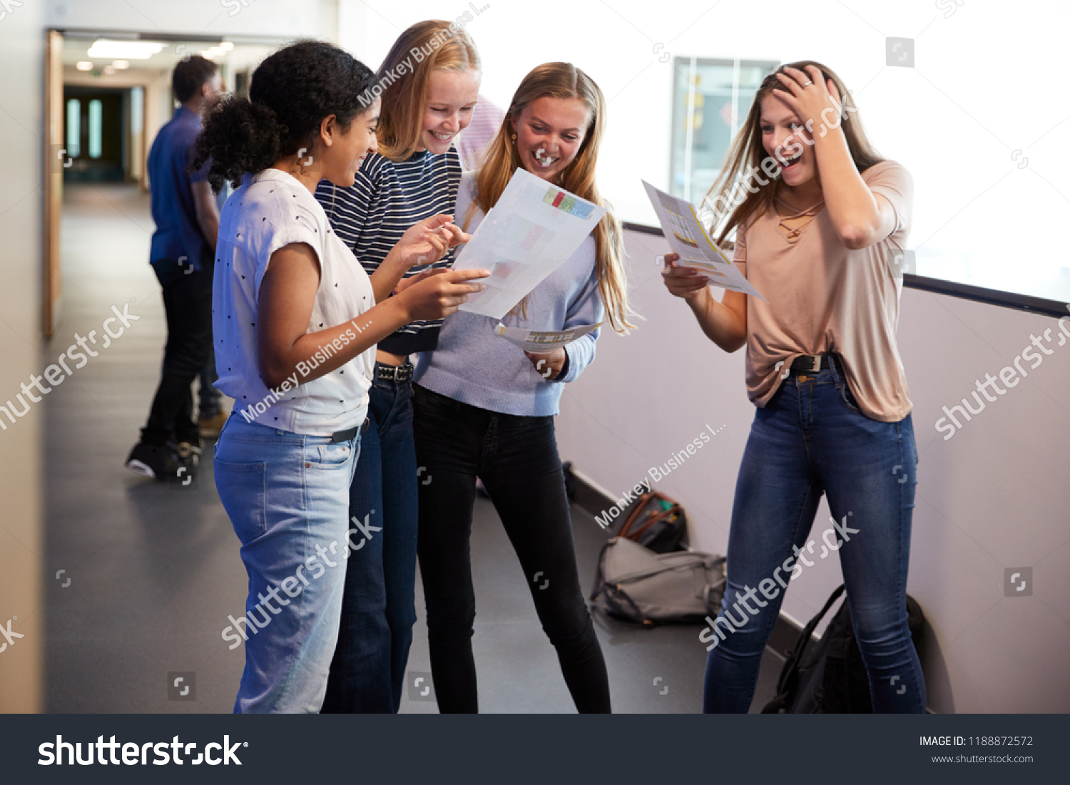 Stock Photo Excited Female Teenage High School Students Celebrating Exam Results In School Corridor 1188872572